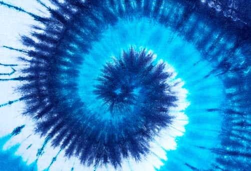 tie dye pattern hand dyed on cotton fabric texture background.