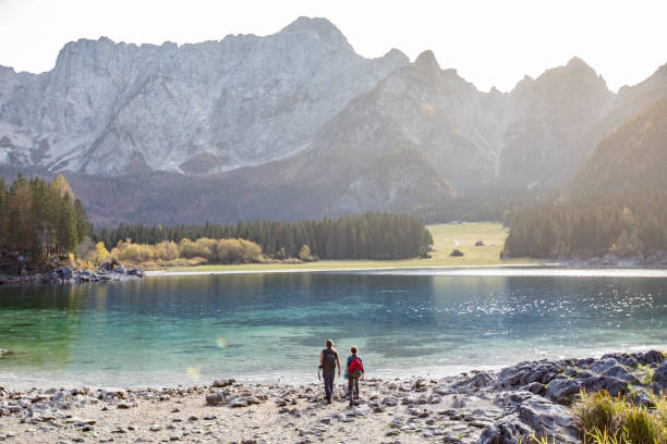 istock Two Adults By a Kettle Lake in Mountains 1201179370