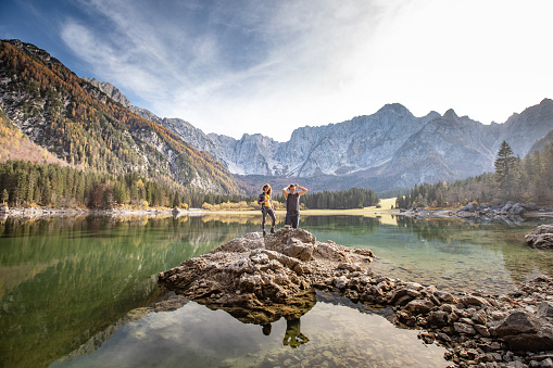 Adult Couple Standing By a Lake in Mountains.