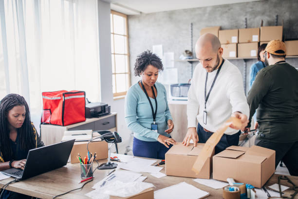 istock Diverse group of people arranging customers orders for drop shipping 1201181377