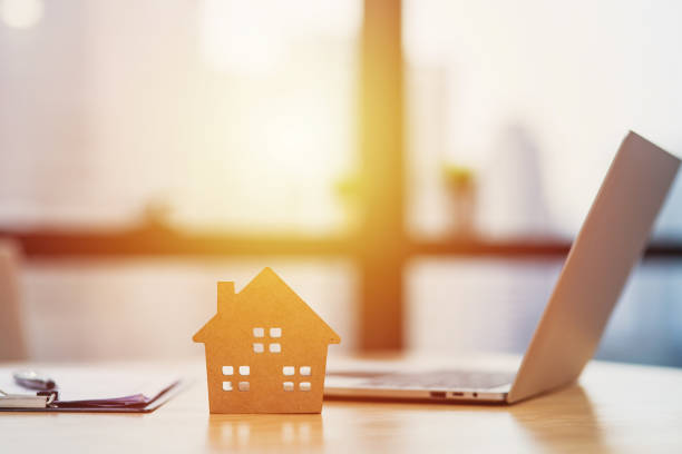 istock Home model put near Lease or Rental agreement document and laptop with copy space 1201183502