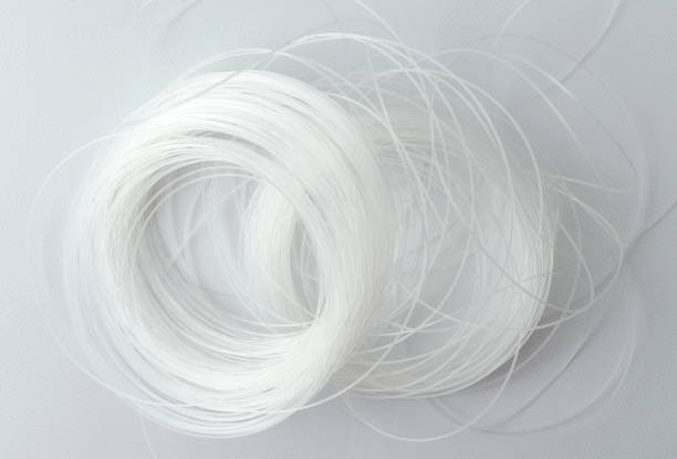 closeup of tangled white fishing line on the white surface - nylon strings imagens e fotografias de stock