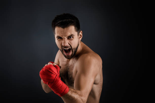 istock boxer throwing a fierce and powerful punch. 1201185237