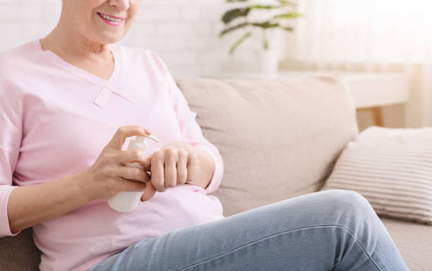 istock Senior lady applying moisturizing cream on hands 1201186077