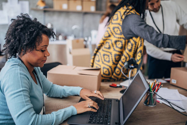 istock Woman using laptop for arranging customers orders for drop shipping 1201187047