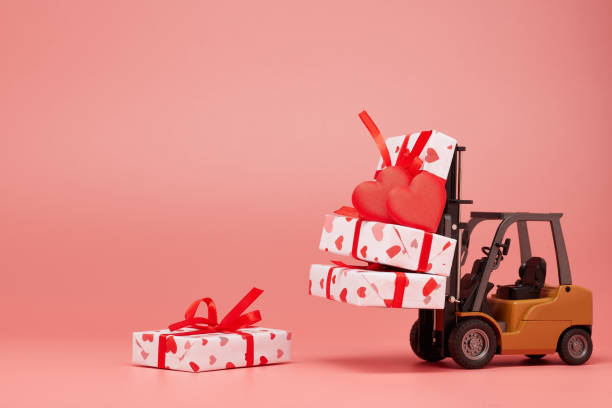 istock Forklift and gift boxes on pink background with copy space. Valentine's Day. 1201187126