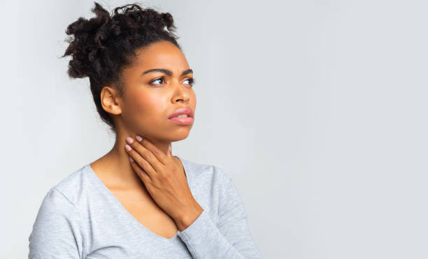 Upset afro girl having pain in her throat Upset afro woman having pain in her throat, touching neck, panorama with copy space follicular thyroid cancer stock pictures, royalty-free photos & images