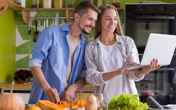 istock Young happy pair enjoying and preparing healthy meal 1201189169