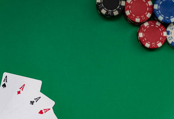 istock Poker table with four aces in one corner and different colored chips in the other corner. Gambling 1201189171
