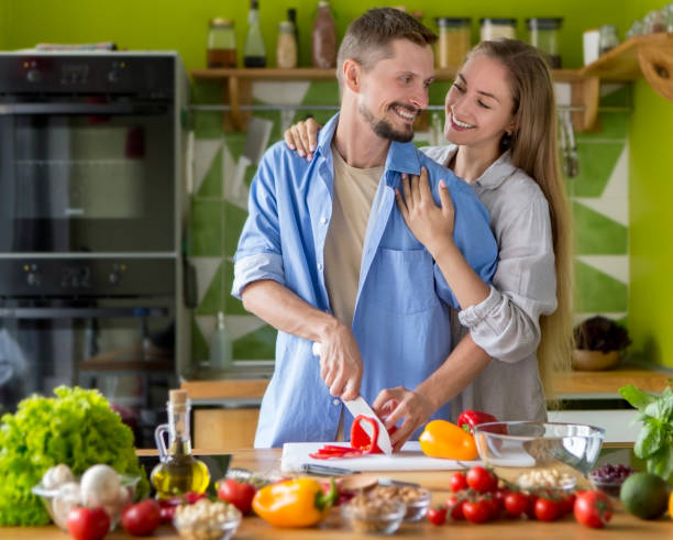 istock Happy romantic young couple preparing a meal 1201190162