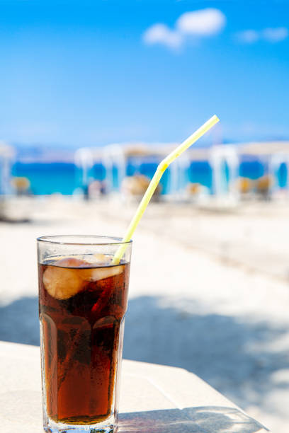istock Cola drink (Cuba Libre cocktail) in the sunny beach. Leisure vacation concept. 1201190553