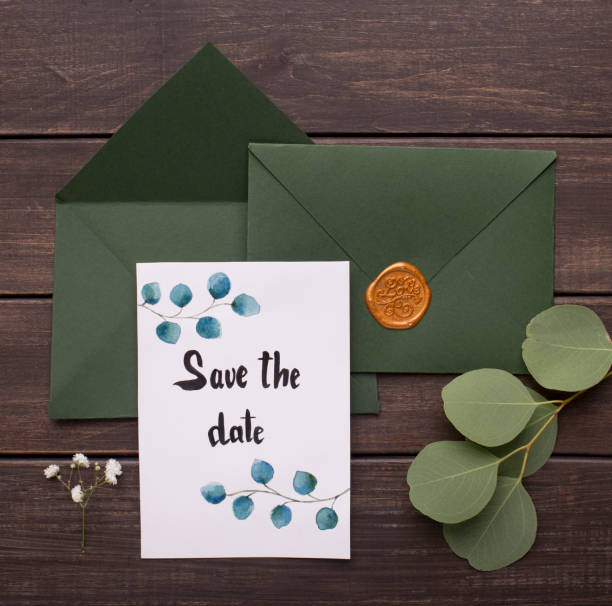 istock Wedding Green envelopes with postcard inside on wood 1201191960