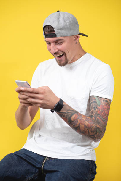 istock Carefree modern man smiling while checking his social media 1201192693