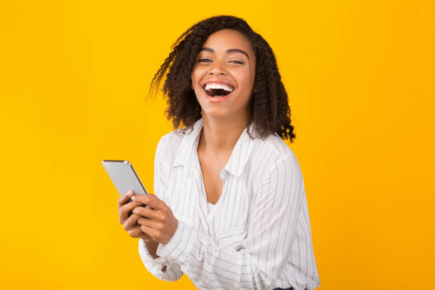 istock Happy afo girl using cell phone looking at camera 1201192819