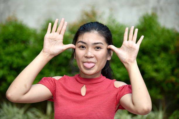 istock Young Asian Girl Making Funny Faces 1201193057