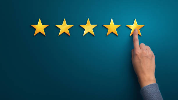 istock Hand of client giving a five star rating on blue background 1201194767