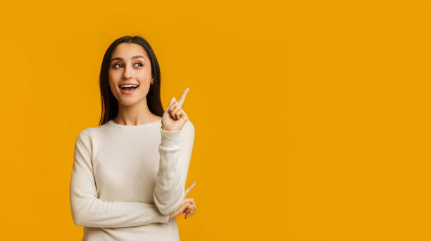 istock Young Brunette Woman Pointing Finger Up, Having Idea Over Yellow Background 1201195004