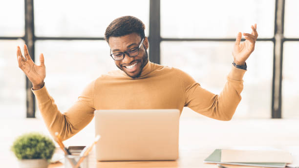 istock Excited black manager celebrating his victory at work 1201195181