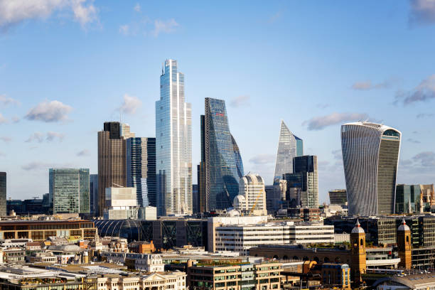 Skyline of City of London with corporate office buildings of at day View of the corporate office buildings of the City of London at day 122 leadenhall street photos stock pictures, royalty-free photos & images