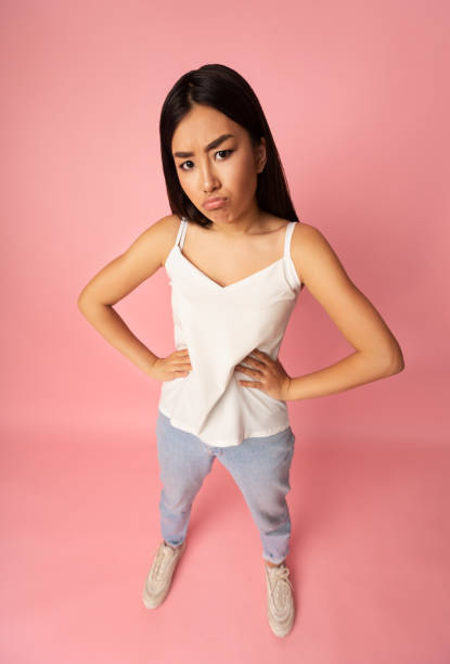 istock Upset asian girl looking at camera, high angle view 1201195594
