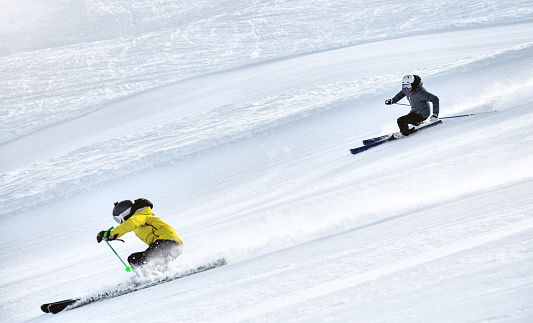 Couple skiing in Alps ski resort, Alpe di Mera, Piedmont, Italy