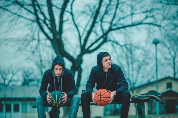 istock Two teenagers relaxing after playing basketball 1201197897