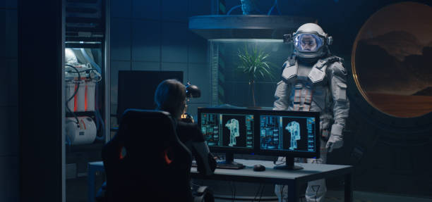 istock Female astronaut helping man with spacesuit 1201198671