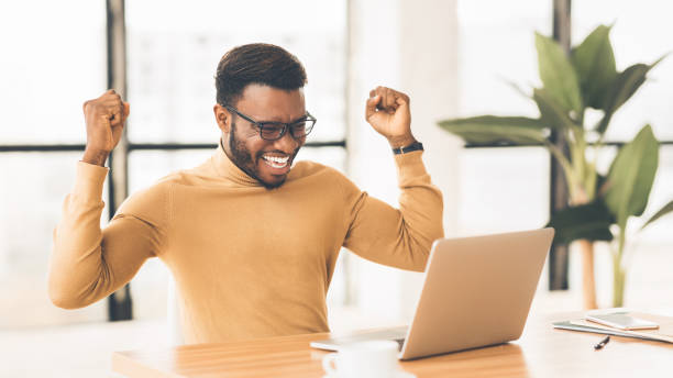 istock Happy african american man celebrating his triumph 1201200130