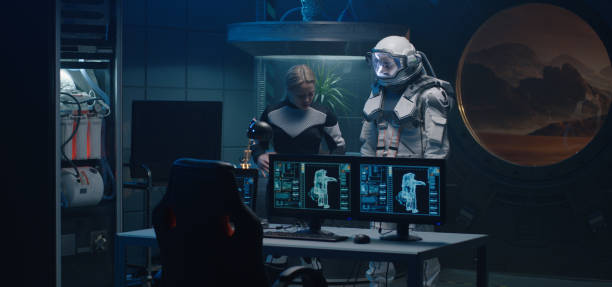 istock Female astronaut helping man with spacesuit 1201200359