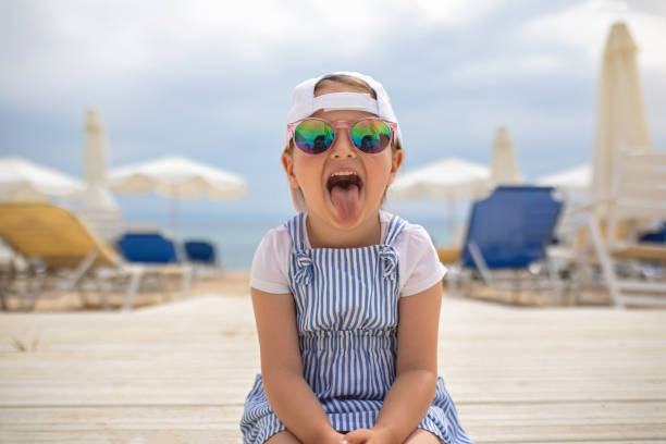 istock Playful cute girl sticking out tounge 1201201902
