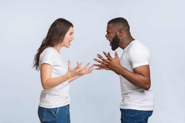 istock Angry interracial couple quarrelling, yelling at each other and emotionally gesturing 1201202093