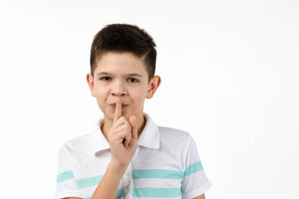 istock cute little boy in t-shirt asking to be quiet 1201204481