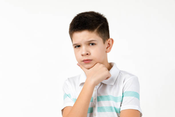 istock Cute little child boy in striped t-shirt thinks about something 1201204608