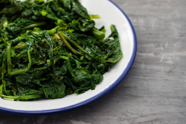 istock boiled greens with garlic on white plate on ceramic background 1201205125