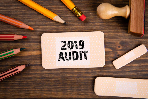 istock 2019 Audit and Review. Reports, documents, business and goals concept. Note sheet like medical plaster 1201207007