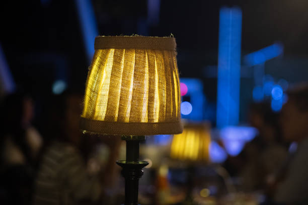 istock Warm lamp on table in restaurant at night 1201207359