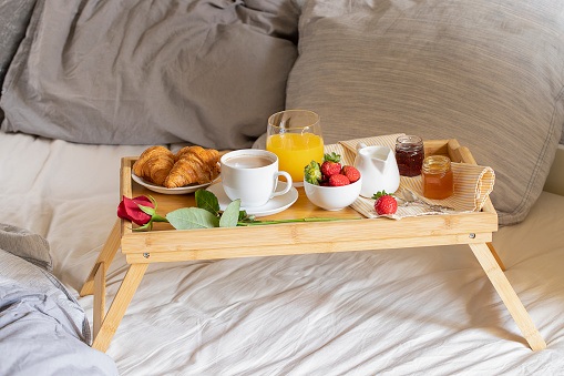 Delicious Breakfast in bed on luxury hotel room. Room service image.