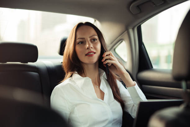 istock Beautiful business lady talking on mobile in car 1201208206