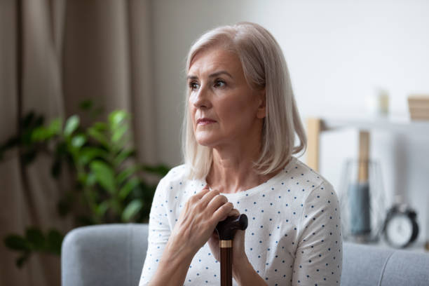 istock Upset senior woman with cane feel lonely thinking 1201208542