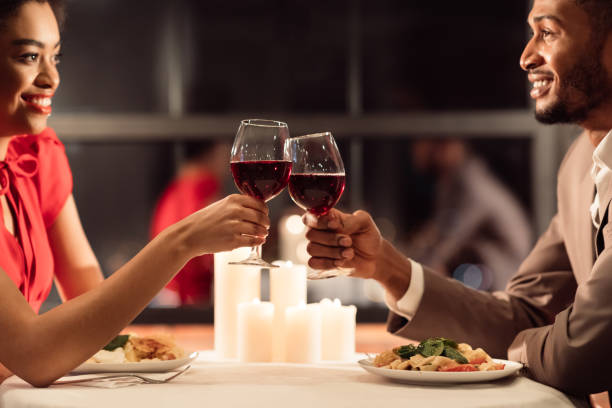 istock African American Spouses Having Romantic Date Clinking Glasses In Restaurant 1201208797