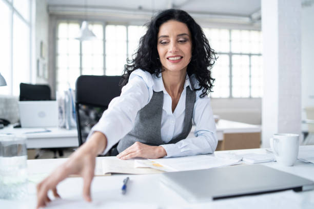 istock Businesswoman working in office, signing documents 1201209398