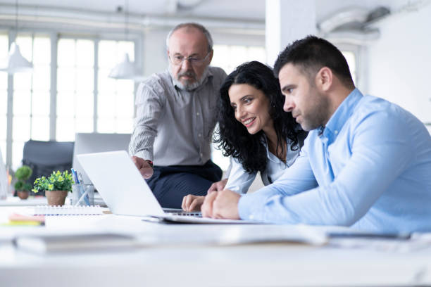 istock Businessteam using laptop and working on project in office 1201209435
