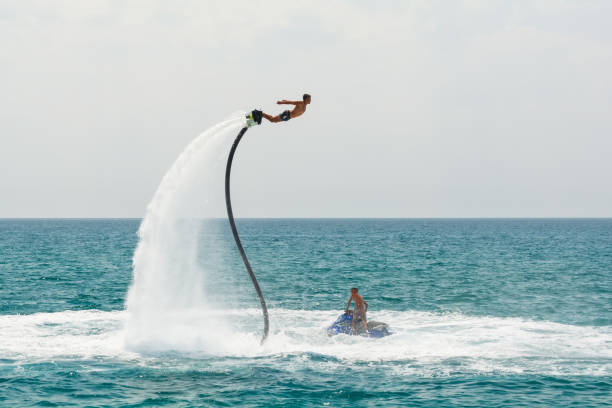 Professional fly board rider on Mediterranean Sea. Water summer extreme sports concept. Kemer, Turkey. Professional fly board rider on Mediterranean Sea. Water summer extreme sports concept. Kemer, Turkey - June 10, 2019. jump jet stock pictures, royalty-free photos & images