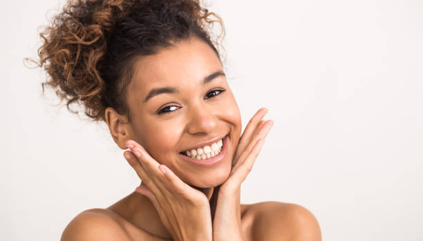 istock Happy afro woman touching her smooth cheeks 1201210172