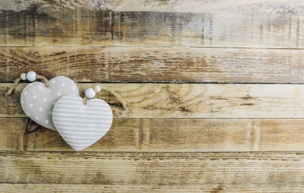 istock Rustic Valentines day background with toy hearts over wooden table. Place for text. 1201210290