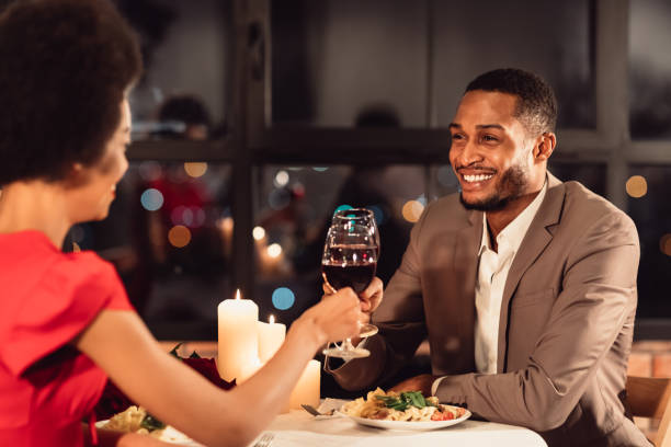 istock Spouses Clinking Red Wine Glasses Celebrating Anniversary In Fancy Restaurant 1201210500