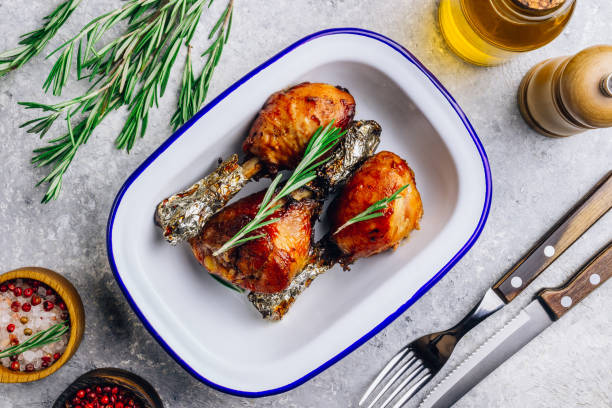 istock Grilled chicken drumstick bbq with rosemary on a stone gray background. 1201210547