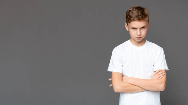 istock Offended teen boy standing with folded arms, panorama 1201210663