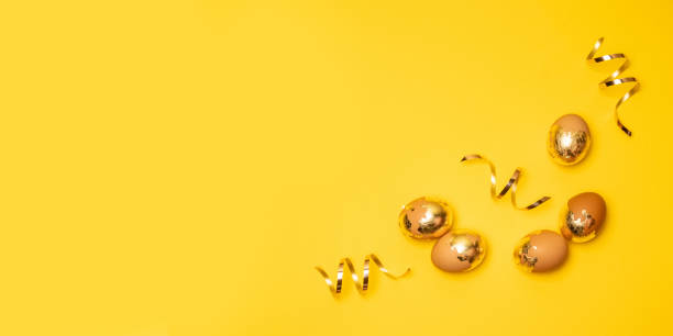 istock Golden eggs and serpentine on a yellow background 1201210698