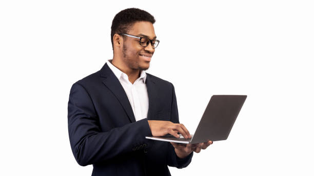 istock Smiling african american guy holding personal computer 1201216728